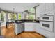 Well-lit kitchen featuring stainless steel appliances, black granite countertops and views to the outdoors at 770 River Cove Dr, Dacula, GA 30019