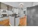 View of the kitchen showing the island, white cabinets, and stainless appliances at 770 River Cove Dr, Dacula, GA 30019