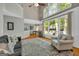 Spacious living room with tall windows and hardwood floors throughout home at 770 River Cove Dr, Dacula, GA 30019