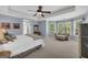 Light-filled main bedroom boasts a tray ceiling, sitting area, and plush carpeting at 770 River Cove Dr, Dacula, GA 30019