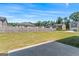Large backyard offers ample green space, a wood fence, and a concrete patio, perfect for outdoor enjoyment at 600 Dairy Dr, Stockbridge, GA 30281