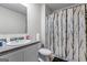 Bathroom featuring modern fixtures including a decorative shower curtain, toilet, vanity, and sink at 600 Dairy Dr, Stockbridge, GA 30281