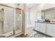 Bright bathroom featuring double sinks, a bathtub, and a glass door shower at 600 Dairy Dr, Stockbridge, GA 30281