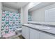 Spacious bathroom featuring double sinks, neutral walls, and a shower/tub combo with butterfly curtain at 600 Dairy Dr, Stockbridge, GA 30281