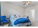 Comfortable bedroom featuring a bed with striped bedding, a ceiling fan, and a connecting bathroom at 600 Dairy Dr, Stockbridge, GA 30281