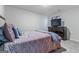 Comfortable bedroom featuring carpet flooring, neutral walls, and a dresser with a TV on top of it at 600 Dairy Dr, Stockbridge, GA 30281
