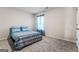 Comfortable bedroom features carpet flooring, neutral walls, and a well-lit window for a relaxing ambiance at 600 Dairy Dr, Stockbridge, GA 30281