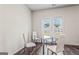Bright dining area featuring hardwood floors and a glass table with white chairs at 600 Dairy Dr, Stockbridge, GA 30281