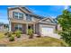 Beautiful two-story brick home featuring an attached two-car garage and professionally landscaped front yard at 600 Dairy Dr, Stockbridge, GA 30281