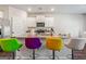 Modern kitchen island featuring stainless steel appliances, granite countertops, and colorful seating at 600 Dairy Dr, Stockbridge, GA 30281