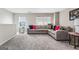 Bright living room featuring a large sectional couch, carpeted floors, and decorative pillows at 600 Dairy Dr, Stockbridge, GA 30281