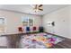 Spacious living room with hardwood floors, a ceiling fan, and a sliding glass door at 600 Dairy Dr, Stockbridge, GA 30281