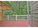 A back deck with a pergola, white railings, and views of lush green trees at 323 Newfield Way, Peachtree City, GA 30269