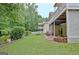 Spacious backyard featuring lush greenery, a well-manicured lawn, and a private patio area at 323 Newfield Way, Peachtree City, GA 30269
