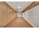 Finished basement featuring wood paneling, white brick, and neutral carpeting at 323 Newfield Way, Peachtree City, GA 30269