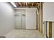 Unfinished basement area featuring exposed brick and peg board at 323 Newfield Way, Peachtree City, GA 30269
