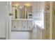 Floral bathroom showcasing a double sink vanity, tiled floors, and a soaking tub at 323 Newfield Way, Peachtree City, GA 30269