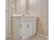 Bathroom vanity with white cabinets and floral wallpaper at 323 Newfield Way, Peachtree City, GA 30269