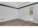 Unfurnished bedroom featuring wood floors and an ensuite bathroom, perfect for relaxation at 323 Newfield Way, Peachtree City, GA 30269