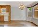 Bright dining area with wood floors, a bay window, chandelier, and direct access to the kitchen at 323 Newfield Way, Peachtree City, GA 30269