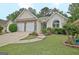 Charming single-story home with stone accents, a two-car garage and well-maintained landscaping at 323 Newfield Way, Peachtree City, GA 30269