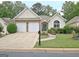 Charming single-story home with stone accents, a two-car garage and well-maintained landscaping at 323 Newfield Way, Peachtree City, GA 30269