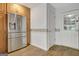 Spacious kitchen with stainless steel refrigerator, wood cabinets, and access to the backyard at 323 Newfield Way, Peachtree City, GA 30269