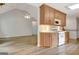 Updated kitchen with wood cabinets, modern appliances, and an open view into the living room at 323 Newfield Way, Peachtree City, GA 30269