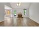 Spacious living room featuring hardwood floors, a fireplace and a sunroom at 323 Newfield Way, Peachtree City, GA 30269