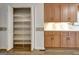 Walk-in pantry with plenty of storage space, conveniently located next to the kitchen cabinets at 323 Newfield Way, Peachtree City, GA 30269