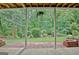 View from covered patio of the beautiful, well-maintained backyard with mature trees and landscaping at 323 Newfield Way, Peachtree City, GA 30269