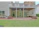 Covered patio with access to the backyard and landscaped garden, perfect for outdoor entertaining at 323 Newfield Way, Peachtree City, GA 30269
