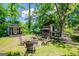 Outdoor living space with a fire pit, shed, and wood storage at 527 W Church St, Villa Rica, GA 30180