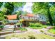 Landscaped backyard featuring a patio, deck, and lush greenery at 527 W Church St, Villa Rica, GA 30180