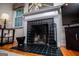 Elegant fireplace with a black tile surround, white mantle, and decorative screen at 527 W Church St, Villa Rica, GA 30180