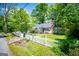 Charming home featuring a white picket fence, lush green lawn, and mature trees at 527 W Church St, Villa Rica, GA 30180