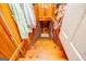 Wooden stairs with brick accents leading to a lower level, illuminated by natural light at 527 W Church St, Villa Rica, GA 30180