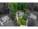 Aerial view of a brick home with a dark roof surrounded by lush green trees and manicured lawns at 119 Crown Springs Dr, Mcdonough, GA 30252
