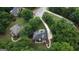 Aerial view showcases a private home with mature trees, long drive, and landscaped grounds in a desirable area at 119 Crown Springs Dr, Mcdonough, GA 30252