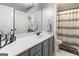 Bathroom features gray vanity with white counter, and large mirror at 119 Crown Springs Dr, Mcdonough, GA 30252