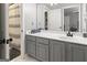 Bathroom features gray cabinets, white countertops, and a large mirror at 119 Crown Springs Dr, Mcdonough, GA 30252