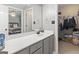 Bathroom featuring gray vanity with white countertop, large mirror, and walk-in closet in view at 119 Crown Springs Dr, Mcdonough, GA 30252