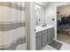 Bathroom with a gray vanity, white countertops, and tile floor, plus shower with striped curtain at 119 Crown Springs Dr, Mcdonough, GA 30252