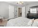 Bedroom with a black dresser, ceiling fan, and view to the hallway with a toddler play table at 119 Crown Springs Dr, Mcdonough, GA 30252