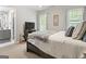 Bedroom features neutral walls and carpet, windows with curtains, and an ensuite bathroom with a gray vanity at 119 Crown Springs Dr, Mcdonough, GA 30252