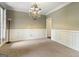 Empty dining room featuring a chandelier and wall trim at 119 Crown Springs Dr, Mcdonough, GA 30252