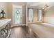 Elegant foyer with hardwood floors and a decorative glass front door at 119 Crown Springs Dr, Mcdonough, GA 30252