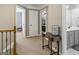Hallway featuring neutral walls, multiple doorways, and an accent table with a decorative lamp at 119 Crown Springs Dr, Mcdonough, GA 30252