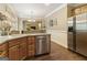 Eat-in kitchen features wood cabinetry, stainless steel appliances, and hardwood flooring at 119 Crown Springs Dr, Mcdonough, GA 30252