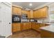 A well-equipped kitchen features wood cabinetry, modern appliances, and an efficient layout for easy cooking at 119 Crown Springs Dr, Mcdonough, GA 30252